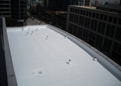 Rooftop in the City with White Foam Insulation